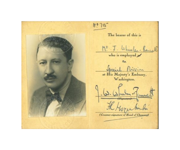 A photograph of John Wheeler Bennett's ID card, with his employment given as 'on special mission at His Majesty's Embassy, Washington'.