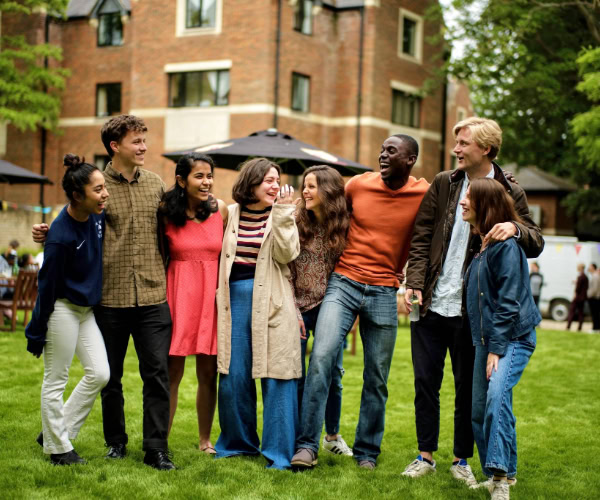 A group of students laugh together.